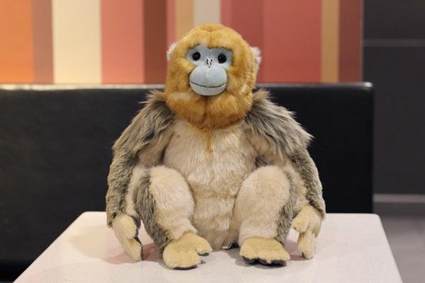 Peluche singe doré réaliste assis