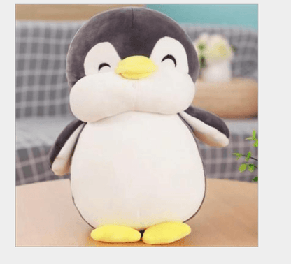 Poupée en peluche pingouin heureux et potelé
