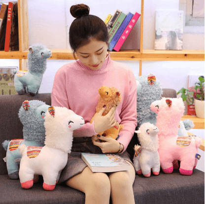 Very cute, cross-eyed and happy alpaca plush doll