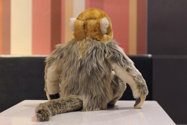 Realistic golden monkey plush toy sitting