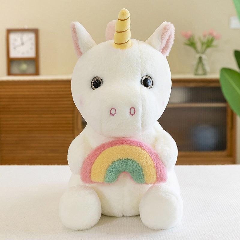 Adorable plush unicorn holding a rainbow