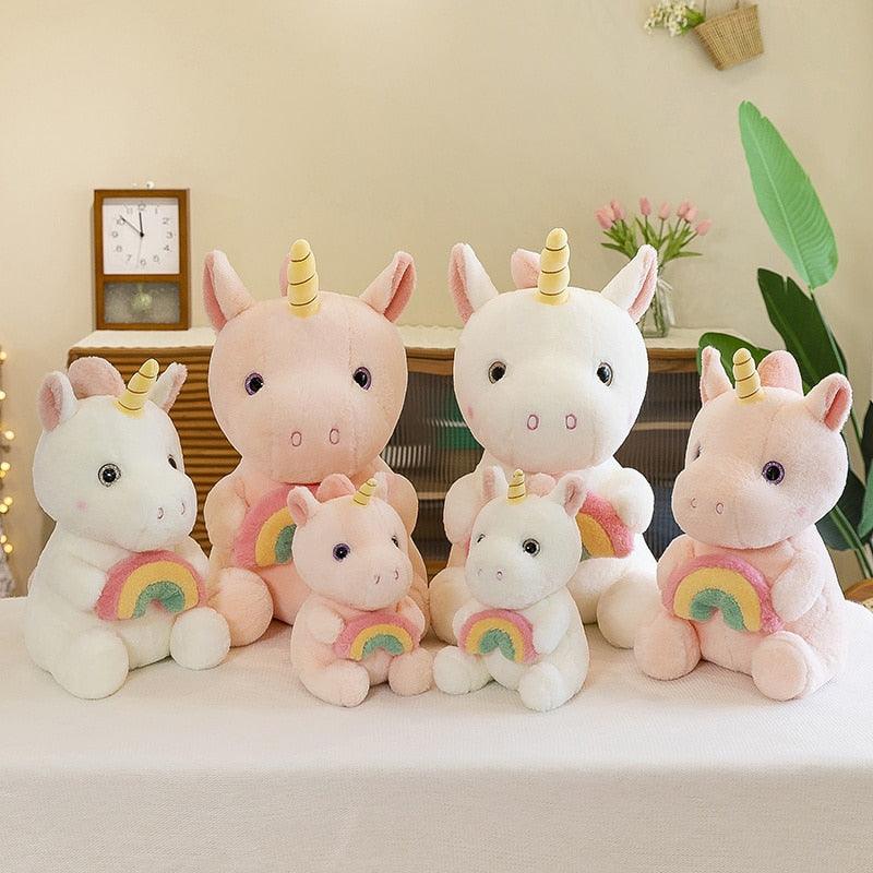 Adorable plush unicorn holding a rainbow