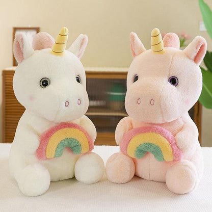 Adorable plush unicorn holding a rainbow