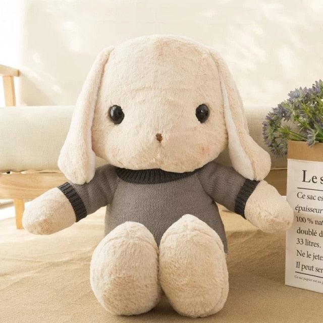 Long-eared rabbit plush wearing a sweater