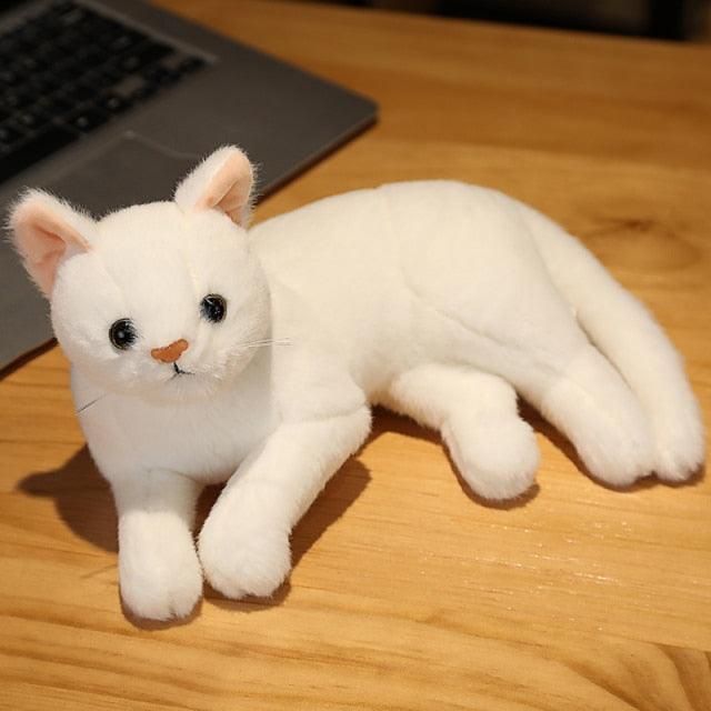 Stuffed animals in the shape of a lying cat